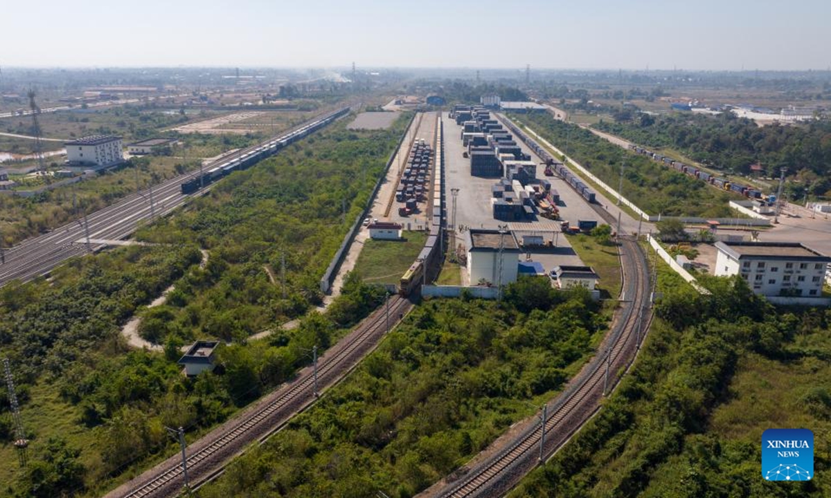 An aerial drone photo shows a container train carrying 1,000 tons of cassava starch bound for Zhengzhou, capital of central China's Henan Province, departing from the Vientiane South Station on the China-Laos Railway in Vientiane, capital of Laos, Nov. 29, 2025. (Photo by Kaikeo Saiyasane/Xinhua)