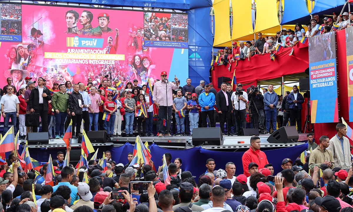 Venezuelan President Nicolas Maduro speaks at a swearing-in event for government-organized community committees at the presidential palace in Caracas on December 1, 2025. Maduro told supporters at the event that Venezuela does not want 