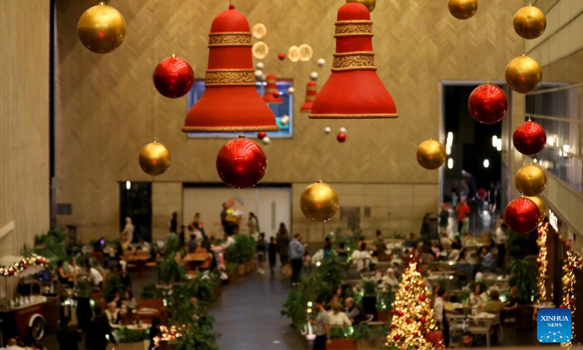 People enjoy the Christmas atmosphere at the Beirut Souks in Beirut, Lebanon, Nov. 29, 2025. The Christmas season kicked off with the lighting of a Christmas tree and the unveiling of festive decorations at the Beirut Souks on Saturday night. (Xinhua/Bilal Jawich)