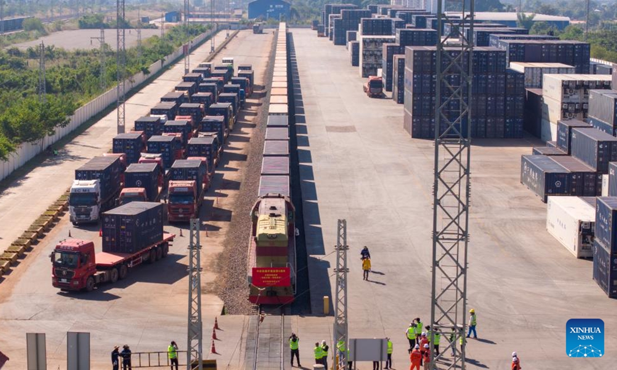 An aerial drone photo shows a container train carrying 1,000 tons of cassava starch bound for Zhengzhou, capital of central China's Henan Province, ready to depart from the Vientiane South Station on the China-Laos Railway in Vientiane, capital of Laos, Nov. 29, 2025. (Photo by Kaikeo Saiyasane/Xinhua)