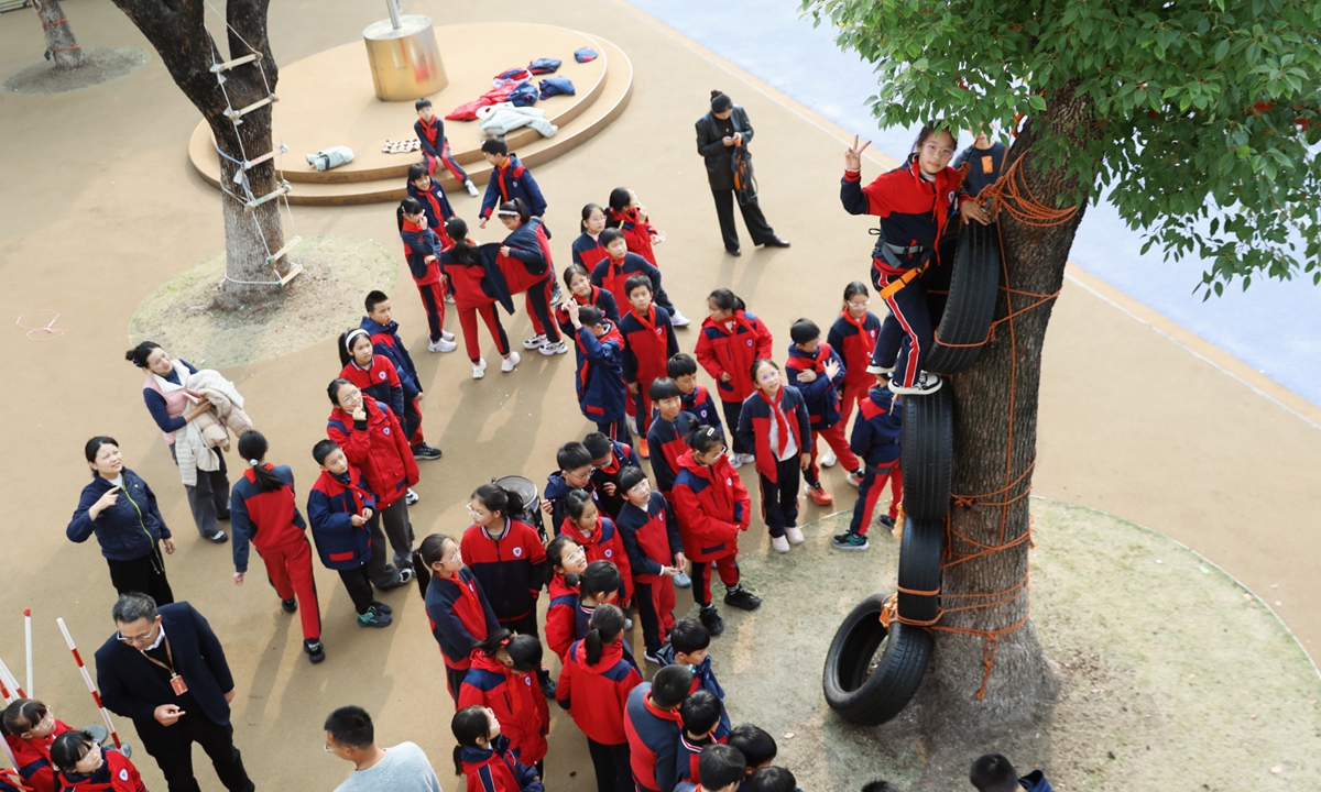 Students attend a tree-climbing class at a primary school in Hangzhou, East China's Zhejiang Province, on December 1, 2025. Trees became the children's 