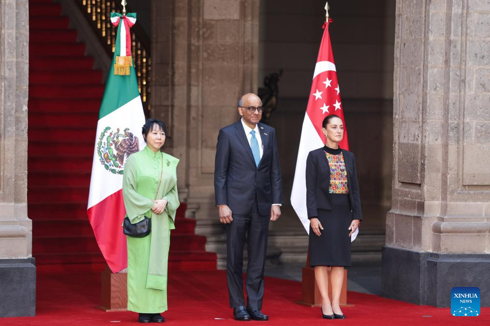 Mexican President Claudia Sheinbaum (R) hosts a welcome ceremony for visiting Singaporean President Tharman Shanmugaratnam (C) at the National Palace in Mexico City, Mexico, on Dec. 1, 2025. (Photo by Francisco Canedo/Xinhua)