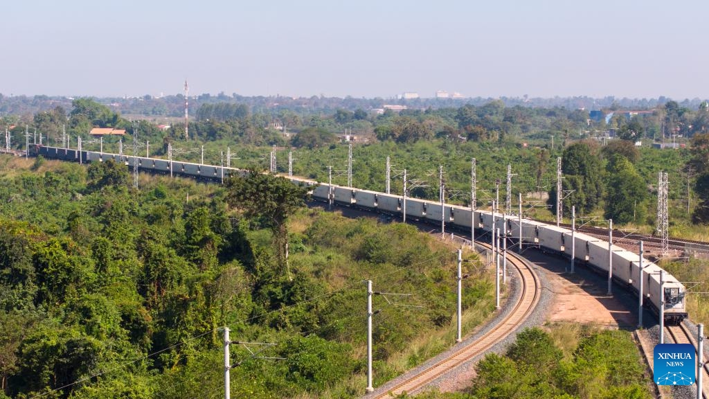 An aerial drone photo shows a container train carrying 1,000 tons of cassava starch bound for Zhengzhou, capital of central China's Henan Province, departing from the Vientiane South Station on the China-Laos Railway in Vientiane, capital of Laos, Nov. 29, 2025. (Photo by Kaikeo Saiyasane/Xinhua)