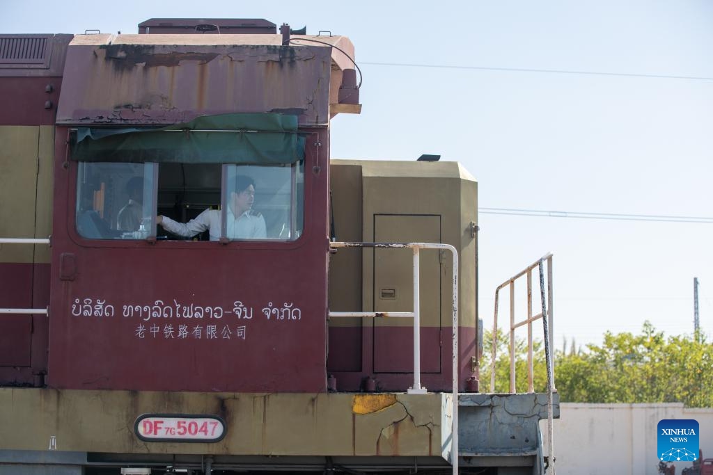 An aerial drone photo shows a container train carrying 1,000 tons of cassava starch bound for Zhengzhou, capital of central China's Henan Province, ready to depart from the Vientiane South Station on the China-Laos Railway in Vientiane, capital of Laos, Nov. 29, 2025. (Photo by Kaikeo Saiyasane/Xinhua)