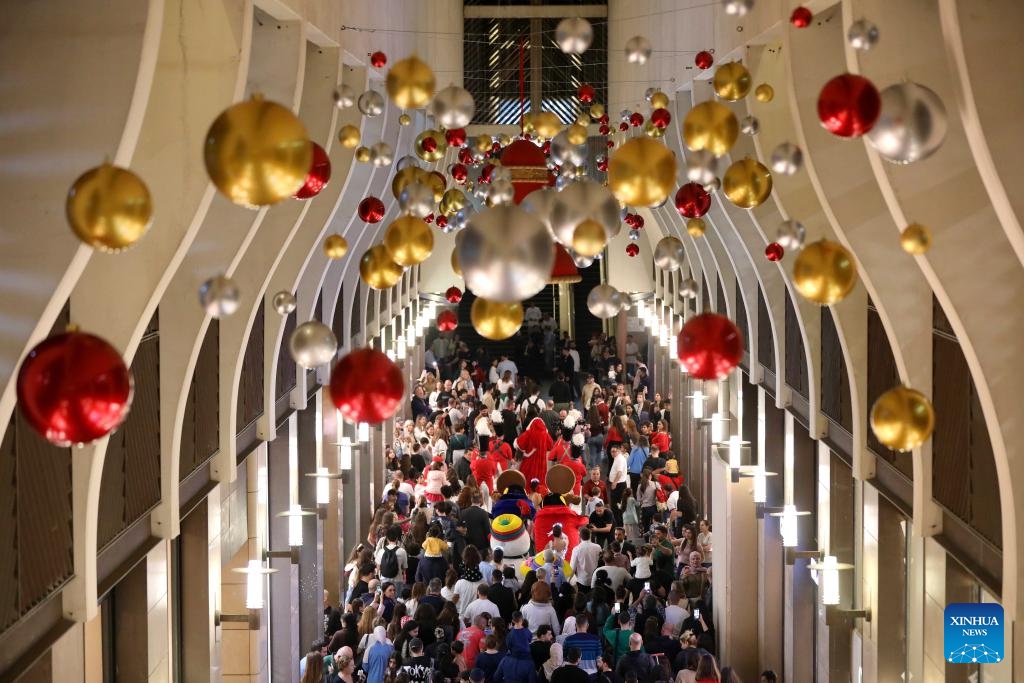 People enjoy the Christmas atmosphere at the Beirut Souks in Beirut, Lebanon, Nov. 29, 2025. The Christmas season kicked off with the lighting of a Christmas tree and the unveiling of festive decorations at the Beirut Souks on Saturday night. (Xinhua/Bilal Jawich)