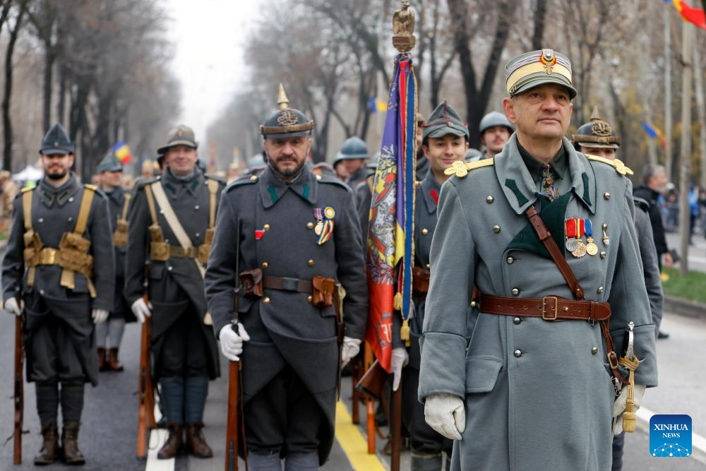 People wearing vintage military uniforms attend a military parade celebrating Romania's National Day in Bucharest, Romania, on Dec. 1, 2025. (Photo by Cristian Cristel/Xinhua)