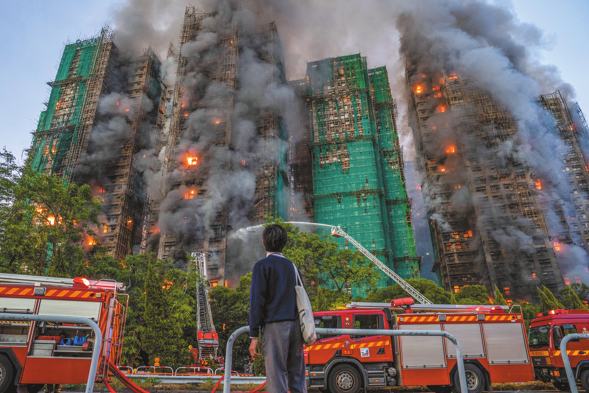 Fire trucks spray water to extinguish a fire at residential buildings at Wang Fuk Court, a residential estate in Tai Po district, HKSAR, on November 26, 2025.