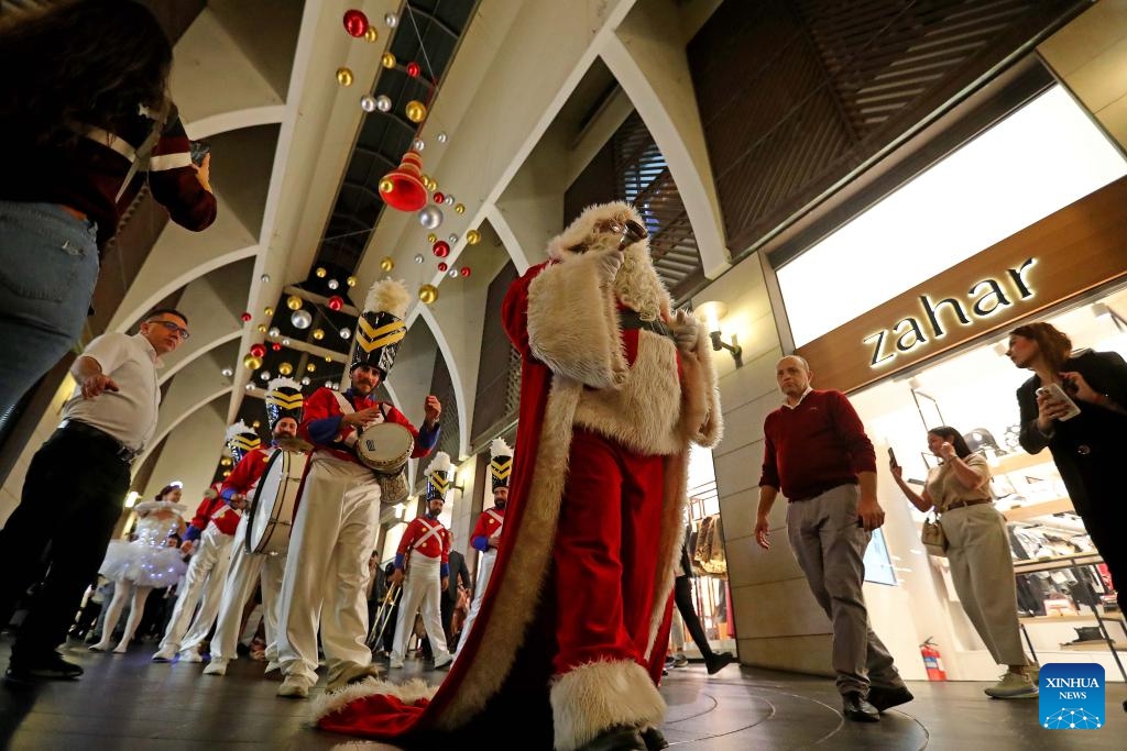 People enjoy the Christmas atmosphere at the Beirut Souks in Beirut, Lebanon, Nov. 29, 2025. The Christmas season kicked off with the lighting of a Christmas tree and the unveiling of festive decorations at the Beirut Souks on Saturday night. (Xinhua/Bilal Jawich)