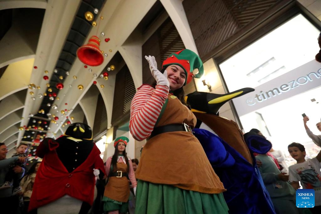 People enjoy the Christmas atmosphere at the Beirut Souks in Beirut, Lebanon, Nov. 29, 2025. The Christmas season kicked off with the lighting of a Christmas tree and the unveiling of festive decorations at the Beirut Souks on Saturday night. (Xinhua/Bilal Jawich)