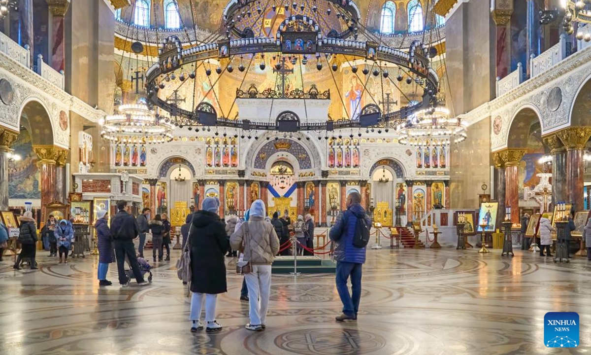 Tourists visit the Naval Cathedral, a landmark in Kronstadt, Russia, Nov. 30, 2025. Kronstadt is located in the Gulf of Finland, 30 kilometers west of St. Petersburg, and is an important naval base of Russia. (Photo by Guo Feizhou/Xinhua)