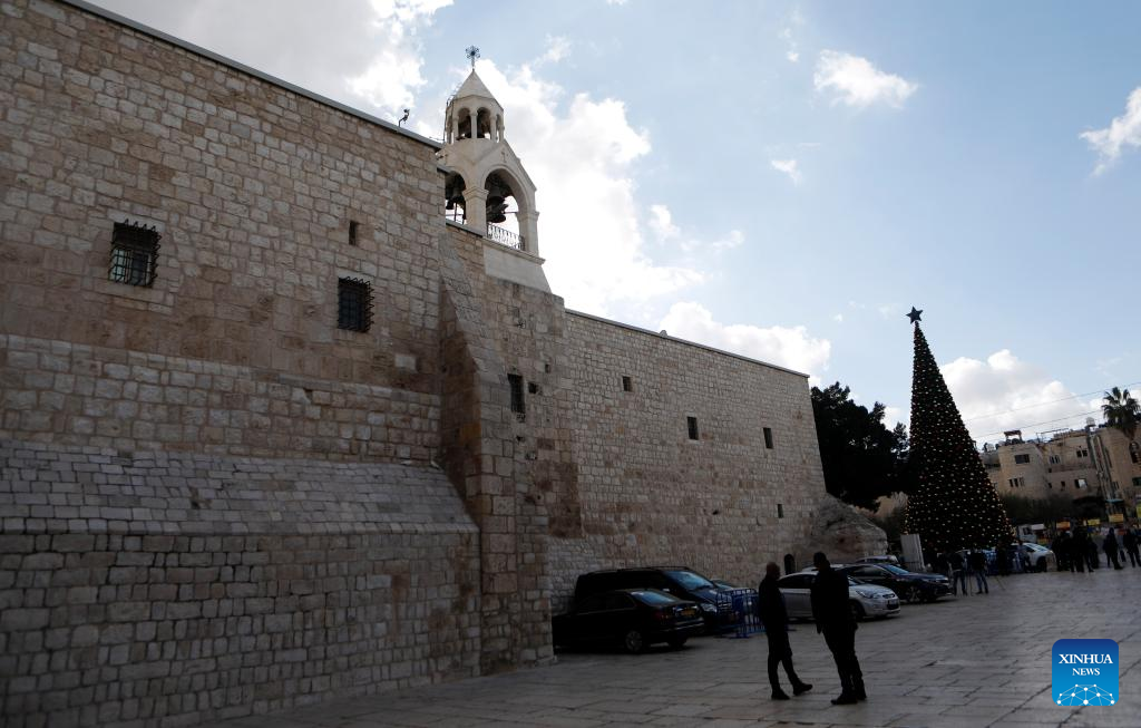 Tourists visit the main Christmas tree in Manger Square in Bethlehem in the West Bank, Dec. 1, 2025. With Christmas nearing, Manger Square and the Church of the Nativity are welcoming more international visitors, bringing hope for a strong and festive season. (Photo by Mamoun Wazwaz/Xinhua)