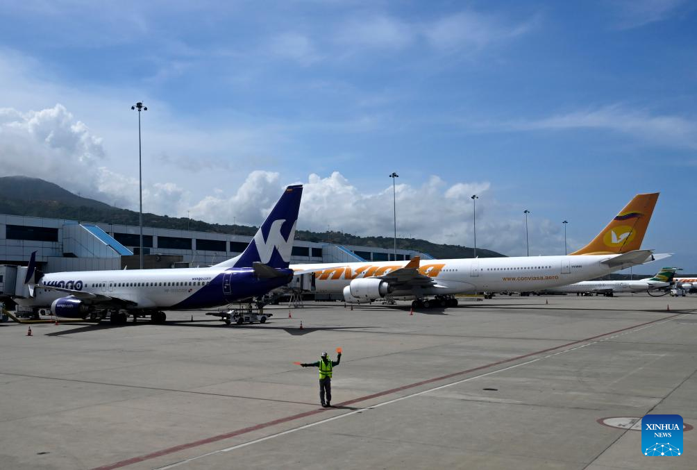 Passenger aircraft are pictured at the Simon Bolivar International Airport in Maiquetia, Venezuela, Dec. 1, 2025. (Xinhua/Li Muzi)