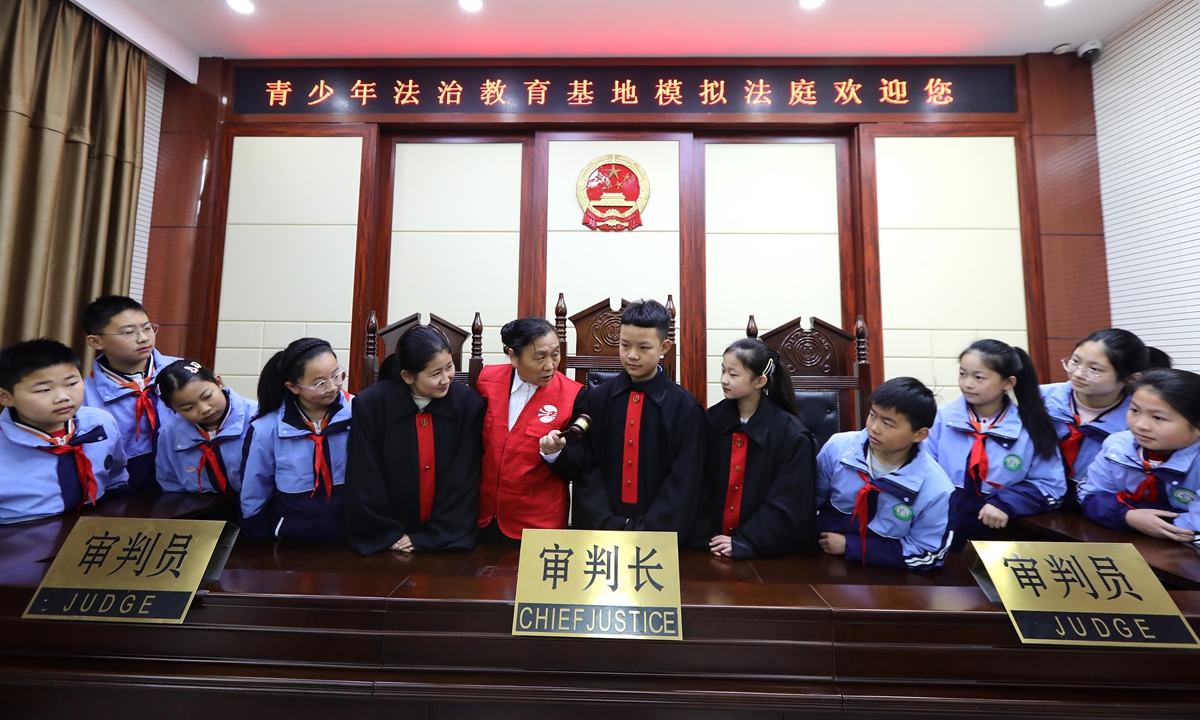 Under the guidance of legal volunteers, children in Gaomi, East China's Shandong Province participate in a mock trial on December 2, 2025, to learn about the Constitution and receive immersive legal education. China's National Constitution Day, which falls on December 4, is set to observe its 12th iteration this year. Photo: VCG