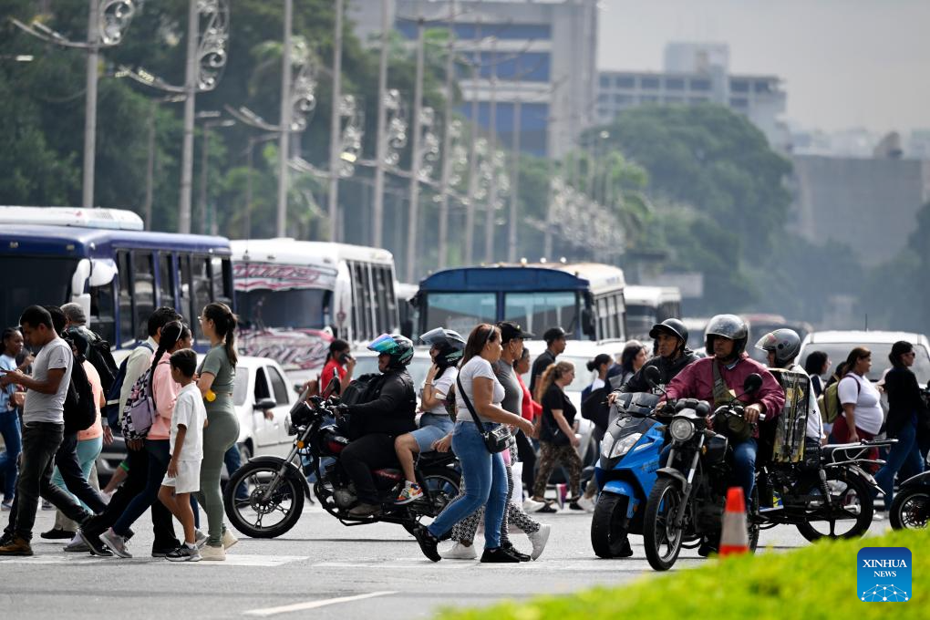 People cross a street during rush hour in Caracas, Venezuela, Dec. 2, 2025. (Xinhua/Li Muzi)