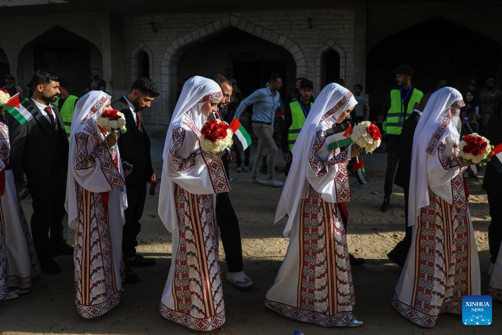 Palestinian grooms and brides celebrate together a mass wedding in the southern Gaza Strip city of Khan Younis, Dec. 2, 2025. Fifty-four couples attended the event. (Photo by Rizek Abdeljawad/Xinhua)