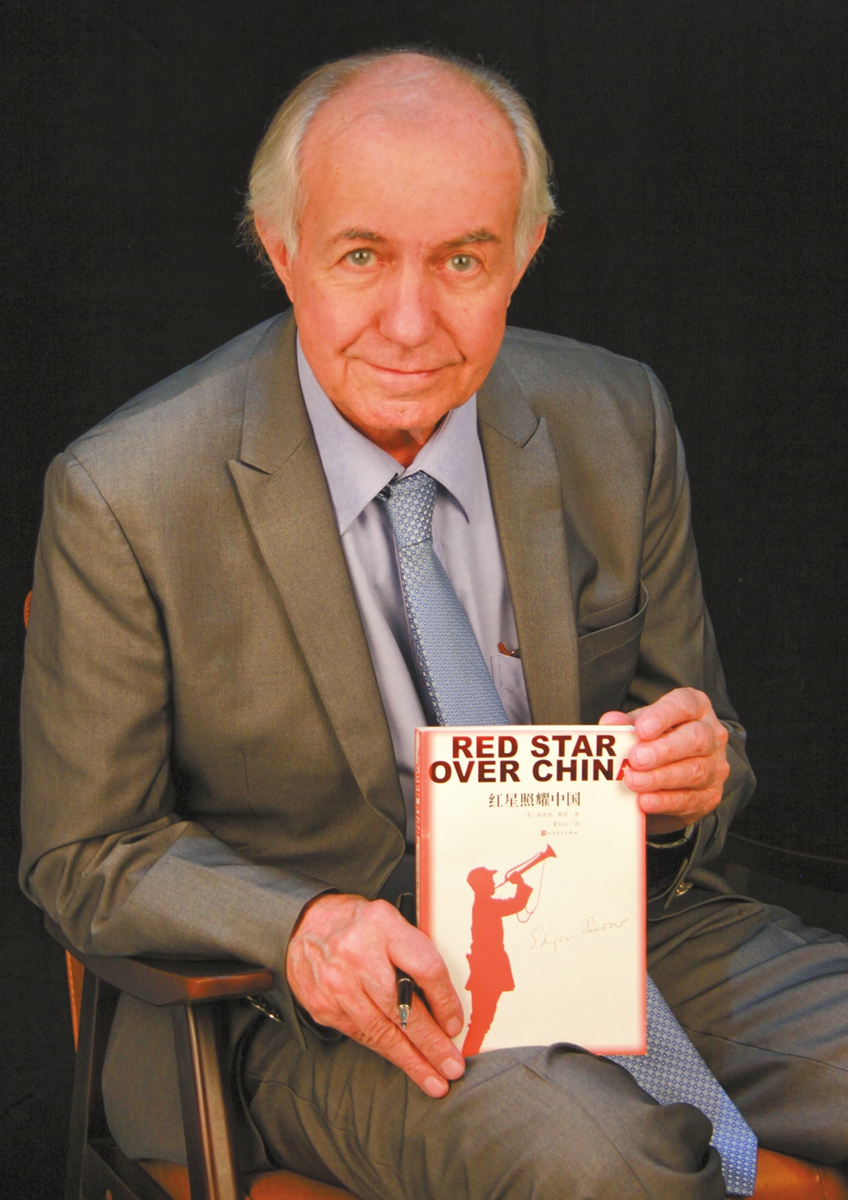 Eric Foster holds up the book Red Star Over China by his uncle Edgar Snow. Photo: Courtesy of Eric Foster