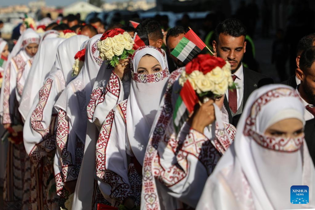 Palestinian grooms and brides celebrate together a mass wedding in the southern Gaza Strip city of Khan Younis, Dec. 2, 2025. Fifty-four couples attended the event. (Photo by Rizek Abdeljawad/Xinhua)