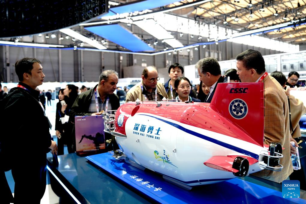 People visit a model of the manned submersible Shenhai Yongshi (Deep Sea Warrior) at an exhibition of the Marintec China 2025 at Shanghai New International Expo Center in Shanghai, east China, Dec. 2, 2025. Attracting over 2,200 enterprises from 16 countries and regions, the event kicked off here on Tuesday and will last until Dec. 5, 2025. (Xinhua/Zhang Jiansong)