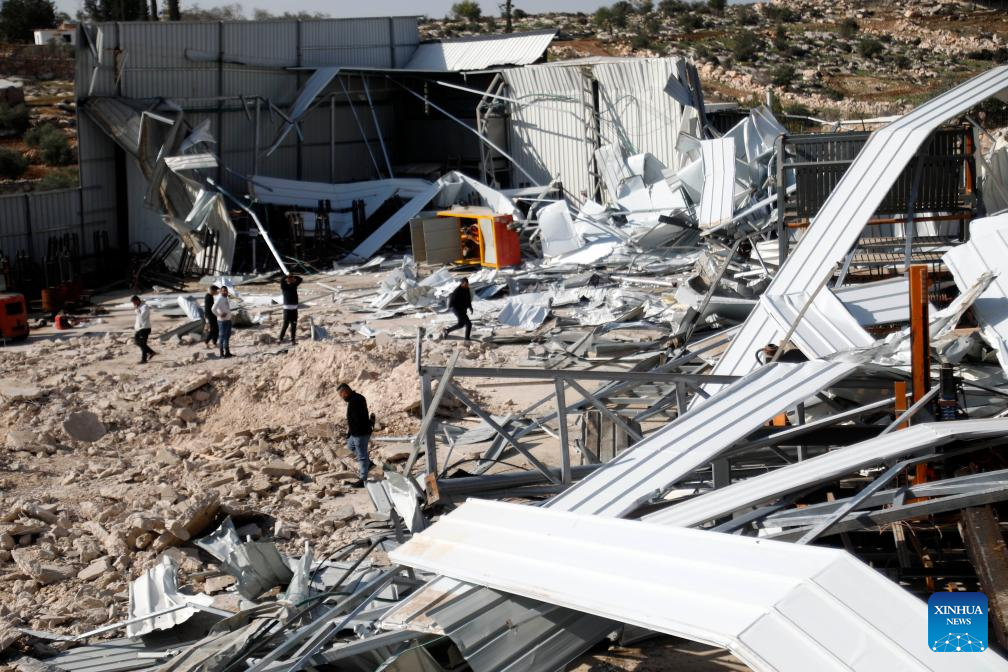 Palestinians inspect a destroyed facility in Beit Oula town northwest of Hebron in the West Bank, on Dec. 3, 2025. (Photo by Mamoun Wazwaz/Xinhua)