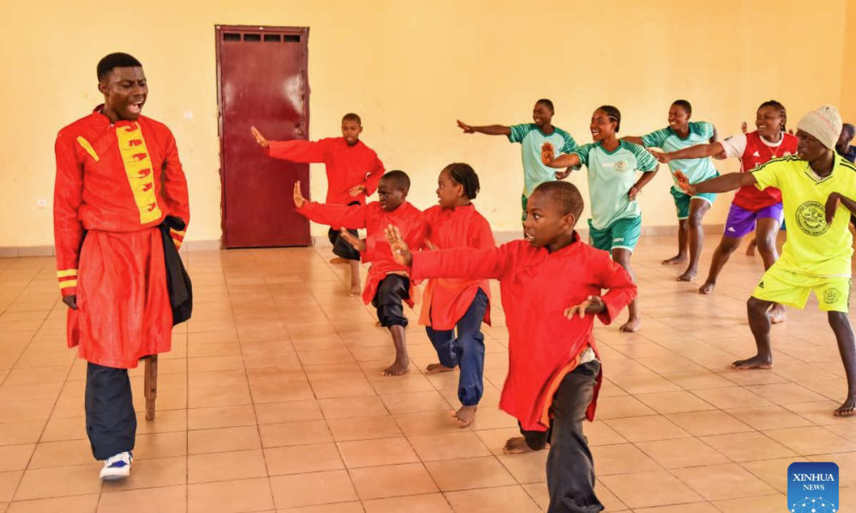 Martin Mangwandjo (1st L), a disabled Cameroonian, leads young learners in practicing Chinese martial arts moves at his training center in Yaounde, Cameroon's capital, Nov. 18, 2025. (Photo by Kepseu/Xinhua)