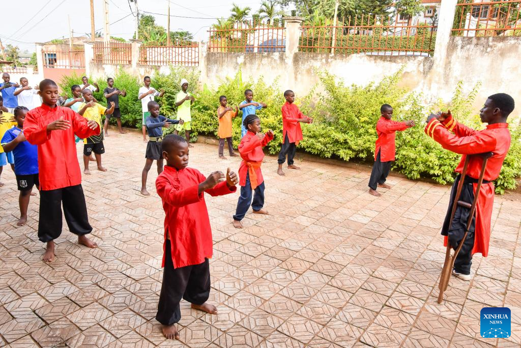 Martin Mangwandjo (1st R), a disabled Cameroonian, leads young learners in practicing Chinese martial arts moves at his training center in Yaounde, Cameroon's capital, Nov. 18, 2025. (Photo by Kepseu/Xinhua)