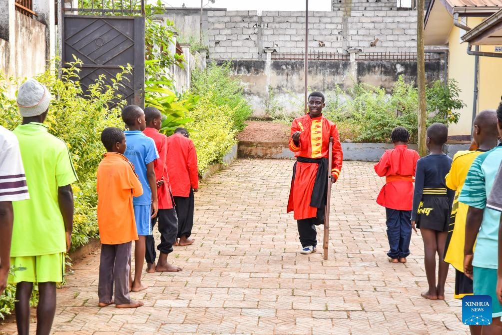 Martin Mangwandjo (C), a disabled Cameroonian, leads young learners in practicing Chinese martial arts moves at his training center in Yaounde, Cameroon's capital, Nov. 18, 2025. (Photo by Kepseu/Xinhua)