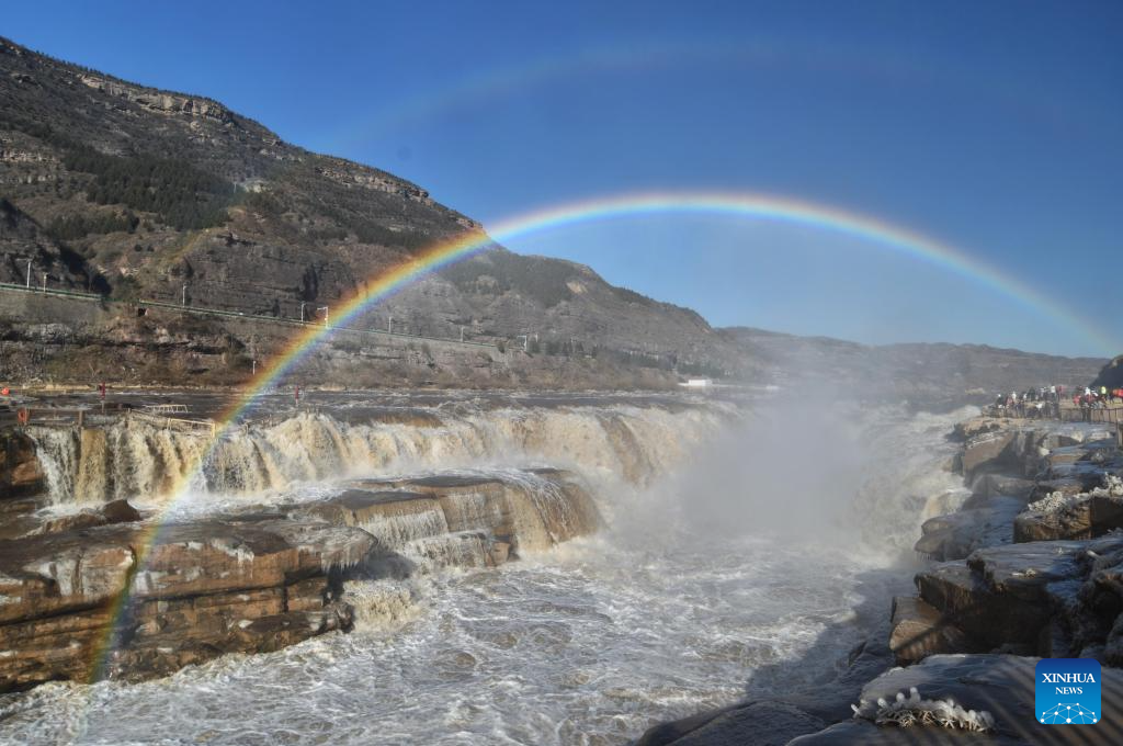 A double rainbow appears in the sky over the Hukou Waterfall in Jixian County, north China's Shanxi Province, Dec. 3, 2025. (Photo by Lyu Guiming/Xinhua)