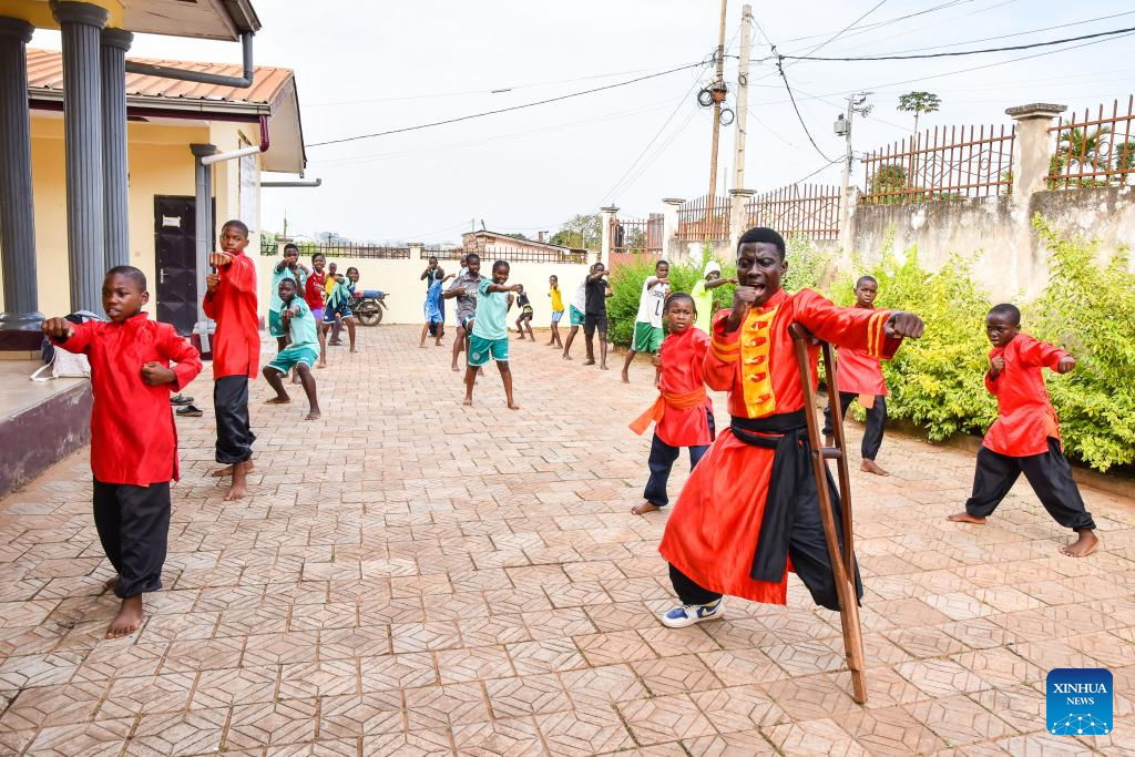 Martin Mangwandjo (front), a disabled Cameroonian, leads young learners in practicing Chinese martial arts moves at his training center in Yaounde, Cameroon's capital, Nov. 18, 2025. (Photo by Kepseu/Xinhua)