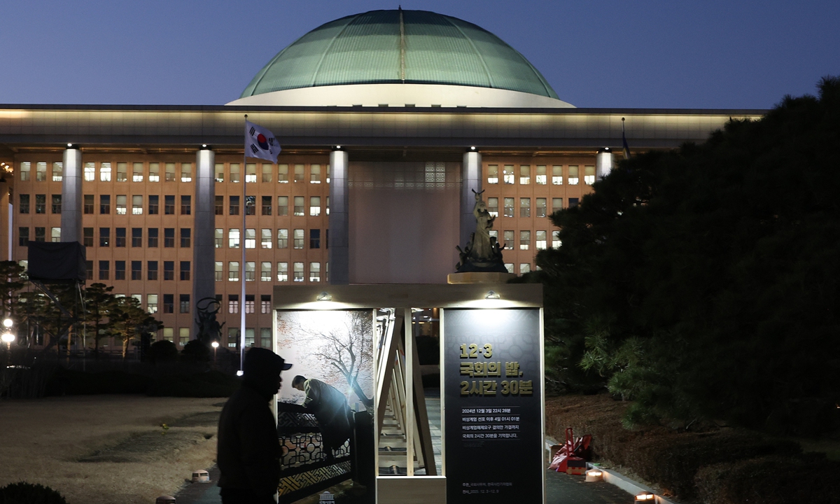 Visitors view a photo exhibition themed on the 