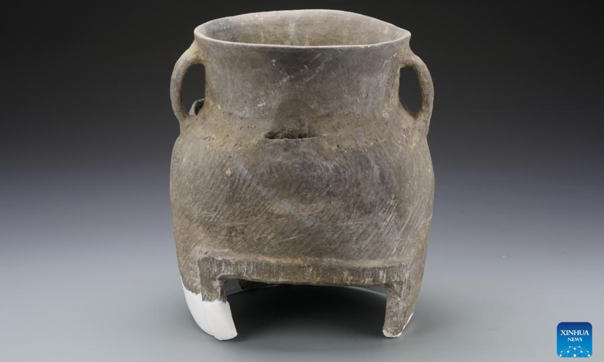 This undated file photo shows a cooking vessel unearthed at the Luojiahe cultural relic site in Chunhua County, Xianyang City, northwest China's Shaanxi Province. Multiple grain storage pits dating back more than 4,000 years were discovered in northwest China's Shaanxi Province, which offer fresh evidence for the study of early civilization in that area, according to archaeologists. The pits were found at the Luojiahe cultural relic site in Chunhua County, Xianyang City, where archaeologists from the Xianyang Cultural Heritage Institute conducted excavations between March 2022 and September 2025. By analyzing the features of the unearthed relics and artifacts and applying scientific methods, the team concluded that the site likely dates back approximately 4,800 to 4,200 years, said Xie Gaowen from the institute. (the Xianyang Cultural Heritage Institute/Handout via Xinhua)
