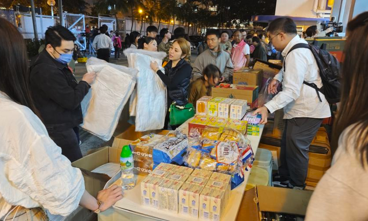 Residents affected by a residential area fire receive relief supplies at a relief station in Hong Kong, south China, Nov. 26, 2025. Photo: Xinhua