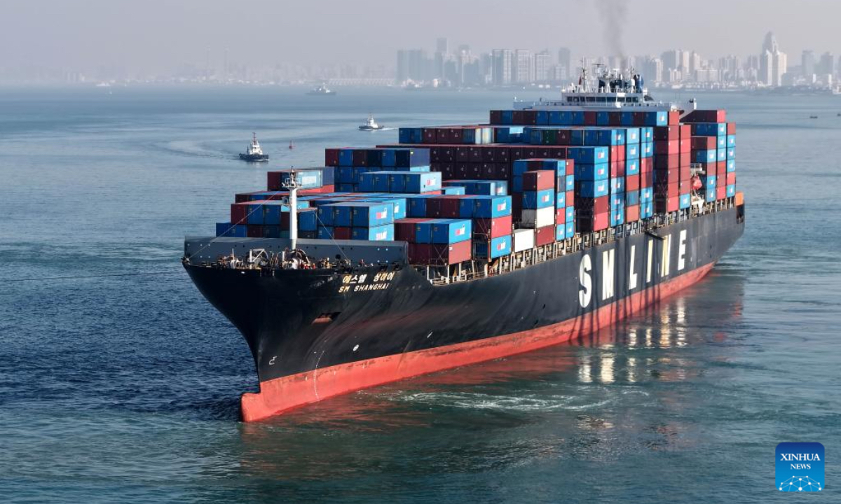 A drone photo taken on Dec. 4, 2025 shows a cargo ship loaded with containers departing from the Qianwan Container Terminal of Qingdao Port in east China's Shandong Province. With nearly 240 foreign trade routes, Qingdao Port connects over 700 ports in more than 180 countries and regions worldwide. (Xinhua/Li Ziheng)