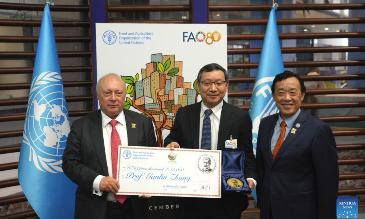 FAO Director-General Qu Dongyu (R) take photos with Zhang Ganlin (C) during the World Soil Day celebration at the FAO headquarters in Rome, Italy, Dec. 5, 2025. Zhang Ganlin, a researcher at the Institute of Soil Science under the Chinese Academy of Sciences, received the 2025 Glinka World Soil Prize on Friday at the World Soil Day celebration held at the headquarters of the Food and Agriculture Organization of the United Nations (FAO) in Rome. (Xinhua/Ren Yaoting)