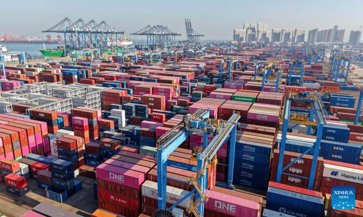 A drone photo taken on Dec. 4, 2025 shows containers waiting for transshipment at the Qianwan Container Terminal of Qingdao Port in east China's Shandong Province. With nearly 240 foreign trade routes, Qingdao Port connects over 700 ports in more than 180 countries and regions worldwide. (Xinhua/Li Ziheng)