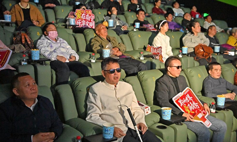Visually-impaired people, together with their family members and volunteers, enjoy a movie at a cinema in Nanning, south China's Guangxi Zhuang Autonomous Region, Dec. 3, 2025. (Xinhua/Zhou Hua)