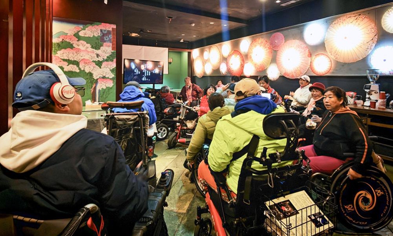 Physically impaired people communicate after a film screening at Trojan Fairy restaurant in Beijing, capital of China, Oct. 26, 2025. (Xinhua/Yin Gang)