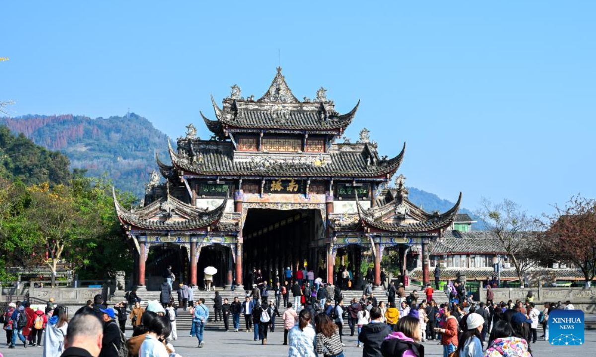 Tourists visit Nanqiao bridge at Dujiangyan scenic area in Chengdu, southwest China's Sichuan Province, Nov. 30, 2025. The Dujiangyan irrigation system, characterized by dam-free water diversion, was built in 256 BC and is the oldest, the only remaining grand water conservancy project in the world, which has withstood the tests of natural disasters such as floods and earthquakes, and is still in use today. A