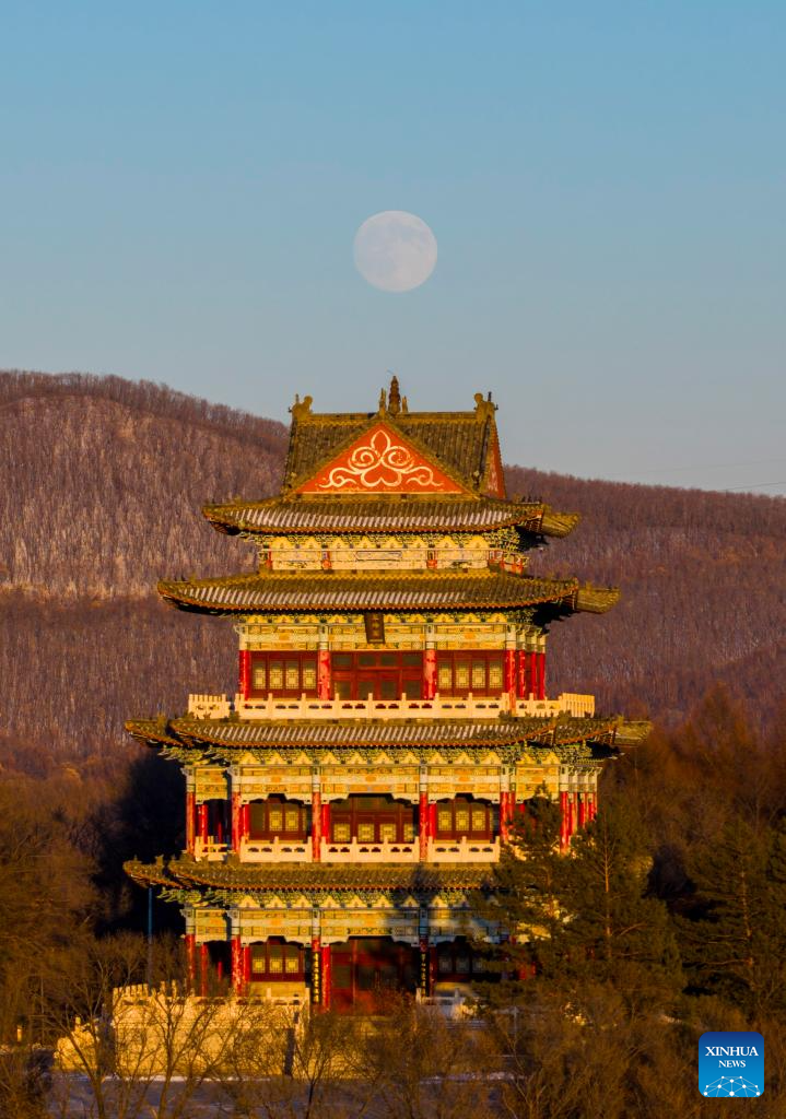 A drone photo taken on Dec. 4, 2025 shows a full moon over a tower in Shuangyashan City, northeast China's Heilongjiang Province. This year's second-largest full moon to the eyes of lunar observers will appear on Friday morning, but the best viewing time falls on Thursday evening. (Photo by Han Yang/Xinhua)