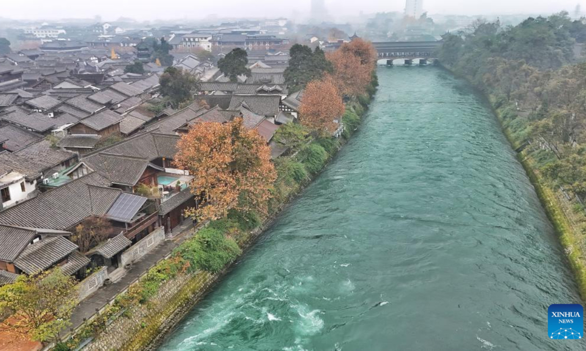An aerial drone photo taken on Dec. 6, 2025 shows the inner channel and an ancient street with a history of 700 years in Dujiangyan City, Chengdu, southwest China's Sichuan Province. The Dujiangyan irrigation system, characterized by dam-free water diversion, was built in 256 BC and is the oldest, the only remaining grand water conservancy project in the world, which has withstood the tests of natural disasters such as floods and earthquakes, and is still in use today. A