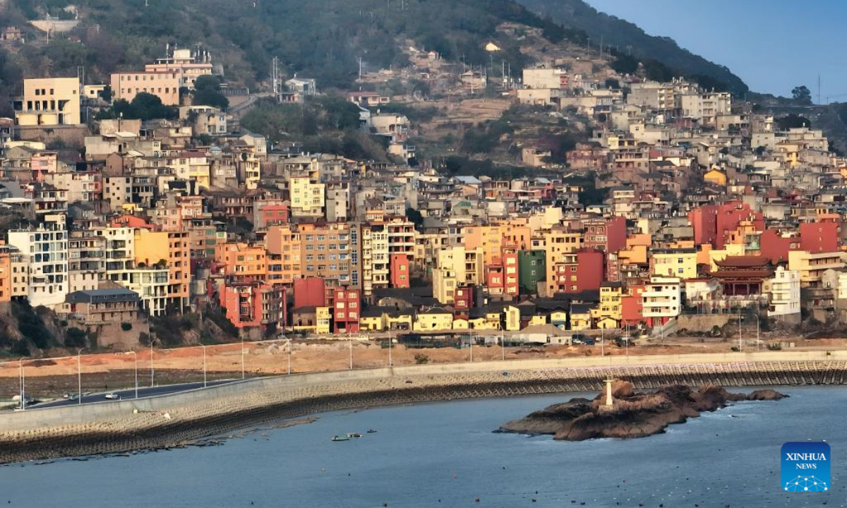 An aerial drone photo shows guesthouses along the coastal road for sightseeing in Sansha Town, Xiapu County, southeast China's Fujian Province, Dec. 3, 2025. Sansha Town in Xiapu County, blessed with unique natural resources and rich historical culture, has been walking a distinctive path to rural revitalization by orchestrating tourist attractions such as high-end homestays, tidal flat landscape and local specialty food with rural development. (Xinhua/Wei Peiquan)