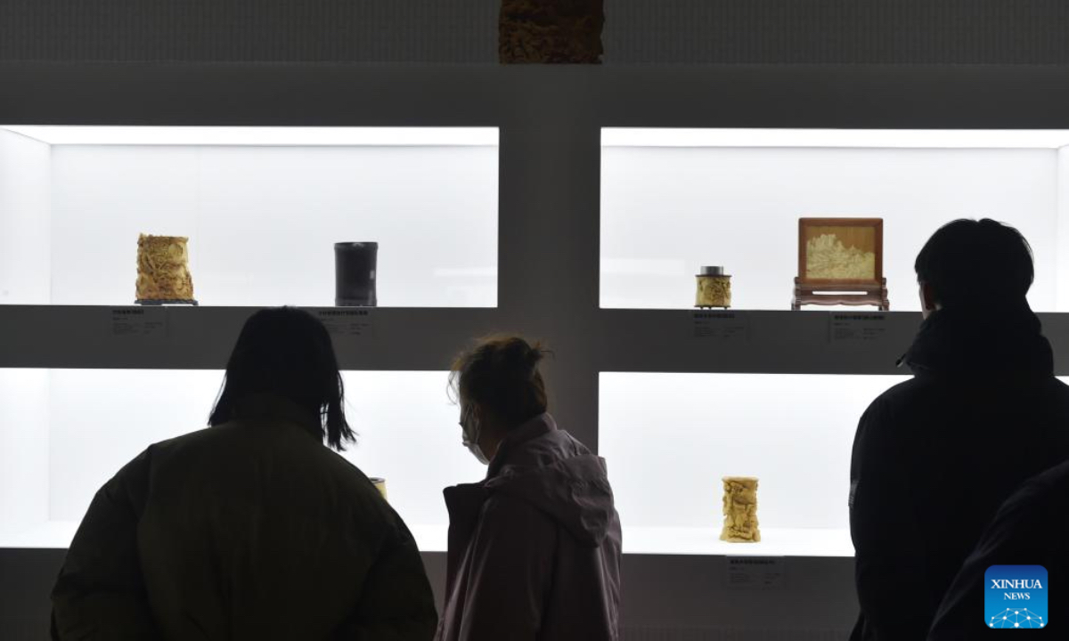 Visitors view exhibits during an exhibition titled 