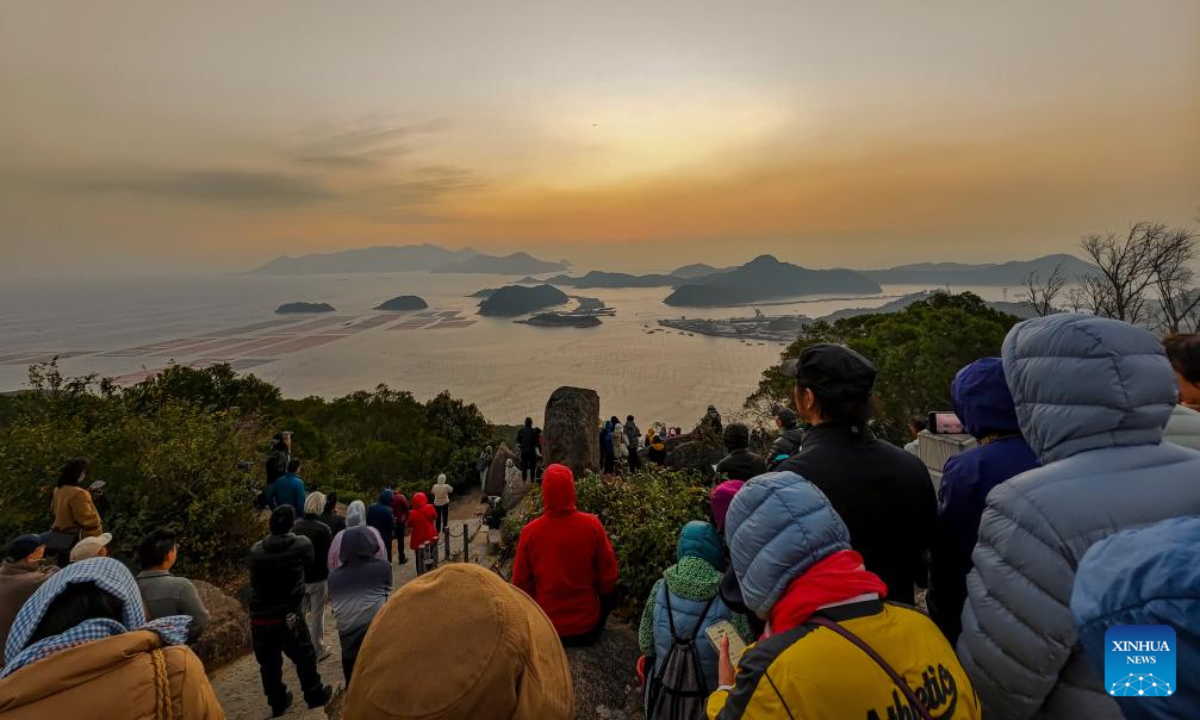 Photography enthusiasts watch and capture sea views at sunrise in Huazhu Village, Sansha Town, Xiapu County, southeast China's Fujian Province, Dec. 4, 2025. Sansha Town in Xiapu County, blessed with unique natural resources and rich historical culture, has been walking a distinctive path to rural revitalization by orchestrating tourist attractions such as high-end homestays, tidal flat landscape and local specialty food with rural development. (Xinhua/Wei Peiquan)