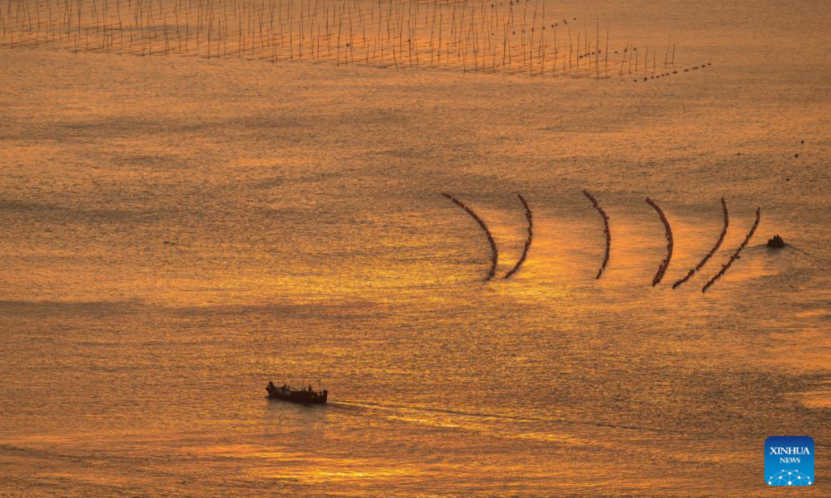 This photo shows the scenery of the sea at sunrise in Huazhu Village, Sansha Town, Xiapu County, southeast China's Fujian Province, Dec. 4, 2025. Sansha Town in Xiapu County, blessed with unique natural resources and rich historical culture, has been walking a distinctive path to rural revitalization by orchestrating tourist attractions such as high-end homestays, tidal flat landscape and local specialty food with rural development. (Xinhua/Wei Peiquan)