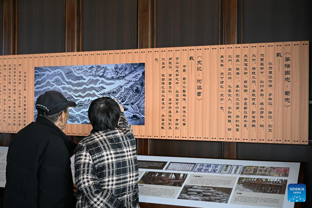 People learn about Dujiangyan irrigation system at Dujiangyan scenic area in Chengdu, southwest China's Sichuan Province, Nov. 30, 2025. The Dujiangyan irrigation system, characterized by dam-free water diversion, was built in 256 BC and is the oldest, the only remaining grand water conservancy project in the world, which has withstood the tests of natural disasters such as floods and earthquakes, and is still in use today. A