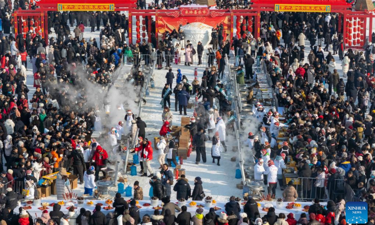 An aerial drone photo taken on Dec. 7, 2025 shows people tasting food at an ice collecting festival in Harbin, northeast China's Heilongjiang Province. Marking the beginning of Harbin's ice collecting season, the sixth ice collecting festival kicked off here by the Songhua River on Sunday, attracting lots of people with ice collecting ceremony and folk custom experience activities. (Xinhua/Zhang Tao)