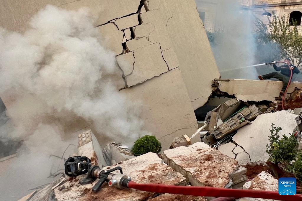 A firefighter attempts to extinguish fire in a building destroyed by Israeli airstrikes in the town of Jbaa, south Lebanon, Dec. 4, 2025. Israeli airstrikes targeted buildings in four towns in southern Lebanon on Thursday afternoon, Lebanon's official National News Agency reported. According to a Lebanese army intelligence source, four buildings were destroyed and around 20 nearby homes were damaged. (Photo by Ali Hashisho/Xinhua)