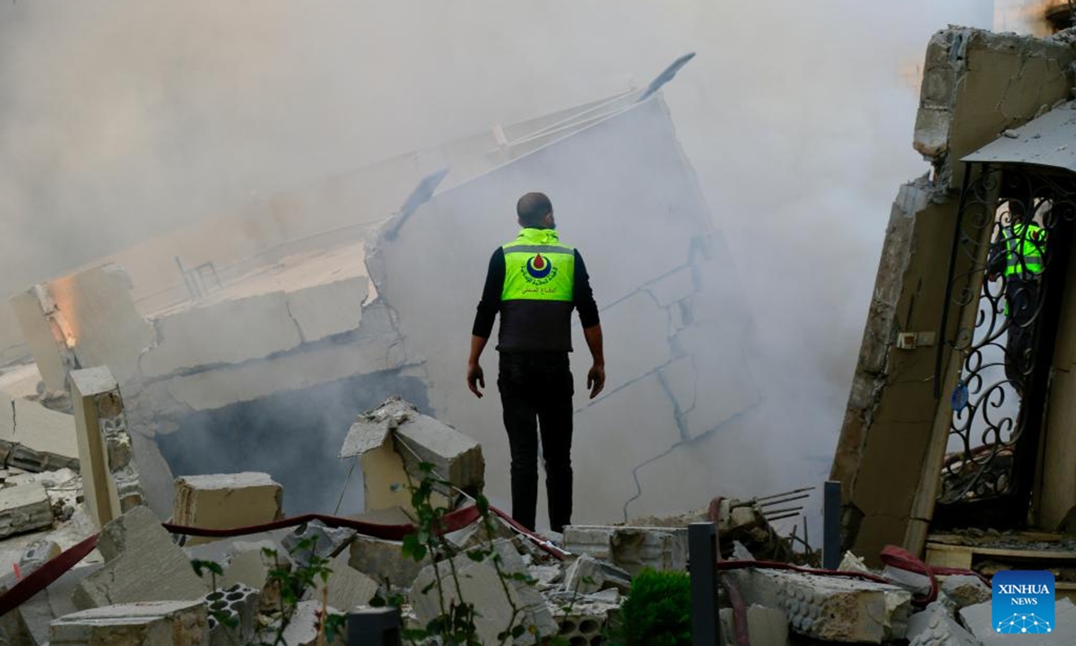 A rescue worker inspects buildings destroyed by Israeli airstrikes in the town of Jbaa, south Lebanon, Dec. 4, 2025. Israeli airstrikes targeted buildings in four towns in southern Lebanon on Thursday afternoon, Lebanon's official National News Agency reported. According to a Lebanese army intelligence source, four buildings were destroyed and around 20 nearby homes were damaged. (Photo by Ali Hashisho/Xinhua)