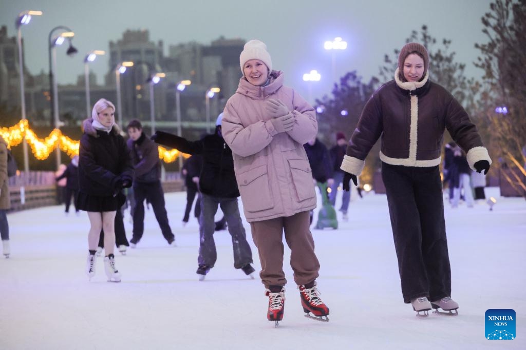 People skate at the Flagpole ice rink in St. Petersburg, Russia, on Dec. 6, 2025. St. Petersburg's Flagpole ice rink officially opened for the season on Saturday. Situated along the Gulf of Finland, the 28,000-square-meter rink is one of the world's largest artificial ice rinks and one of the most popular winter attractions in St. Petersburg. (Photo by Irina Motina/Xinhua)