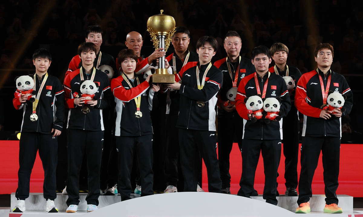 Members of the Chinese national table tennis team celebrate with the trophy after beating Japan in the final match of the International Table Tennis Federation (ITTF) Mixed Team World Cup 2025 in Chengdu, Southwest China's Sichuan Province, on December 7, 2025. China beat Japan 8-1 to claim its third consecutive ITTF Mixed Team World Cup title. Photo: VCG