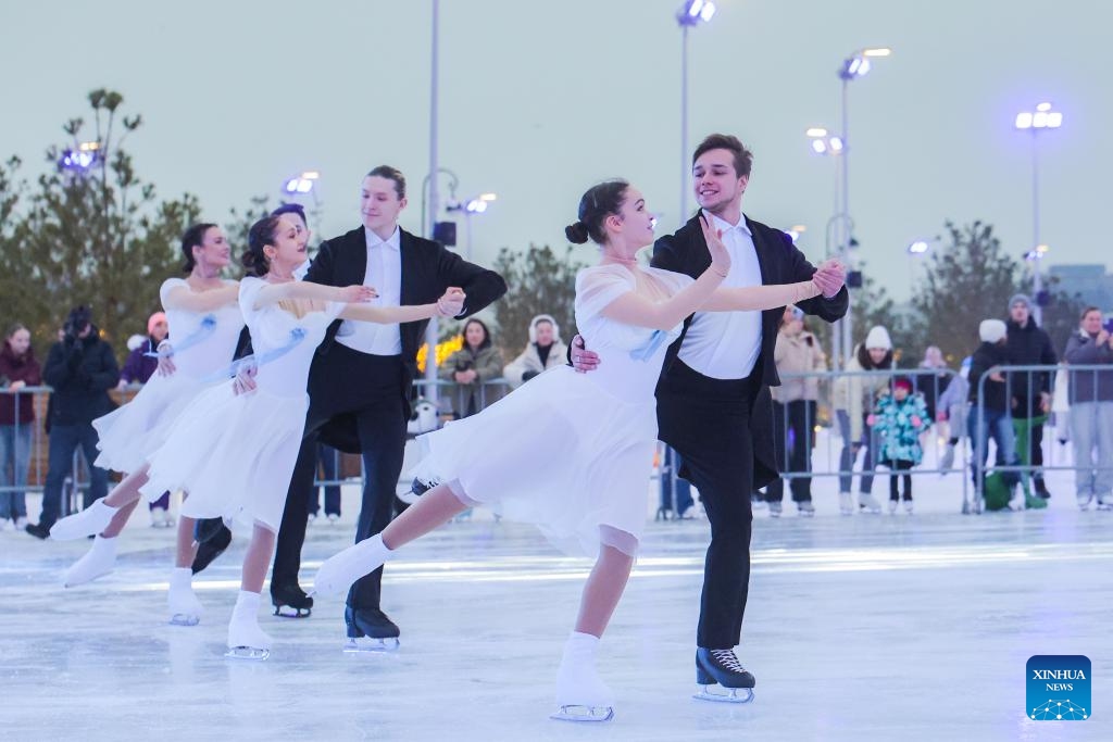 People skate at the Flagpole ice rink in St. Petersburg, Russia, on Dec. 6, 2025. St. Petersburg's Flagpole ice rink officially opened for the season on Saturday. Situated along the Gulf of Finland, the 28,000-square-meter rink is one of the world's largest artificial ice rinks and one of the most popular winter attractions in St. Petersburg. (Photo by Irina Motina/Xinhua)